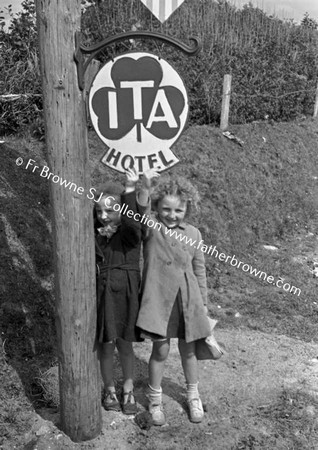 CHILDREN WAITING IN GROUP AT SIDE OF ROAD